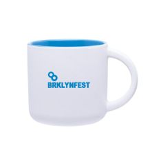 white ceramic mug with a blue inside and an imprint saying brklynfest
