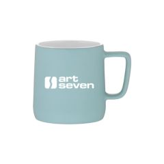 mint ceramic mug with a white inside and an imprint saying art seven