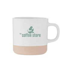 White ceramic mug with a speckled finish and natural colored base with an imprint of coffee beans and text saying tea coffee store