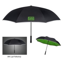 black umbrella with a green underside with an imprint saying Dakel Manufacturing