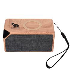 wood grain bluetooth speaker with gray screening and black holding strap and a wireless charger on top