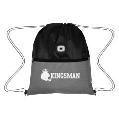 a black backpack with gray trim on the bottom, front pocket, and an imprint saying Kingsman