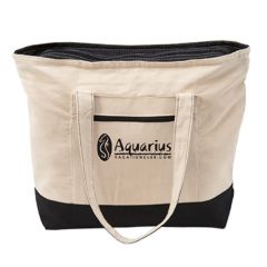 a natural tote bag with black trimming, front pocket, main zippered compartment, and an imprint saying Aquarius Vacationclub.com