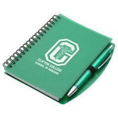 green notebook with a matching pen and an imprint saying Clifton College School Of Nursing