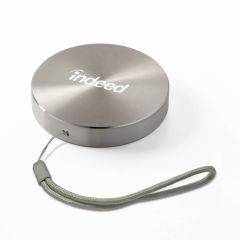 gunmetal round power bank with a strap and an imprint on top saying indeed
