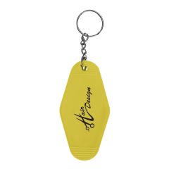 yellow motel keychain with an imprint saying hair designs