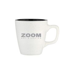 white mug with a black inside and an outside speckled with an imprint saying zoom art & design