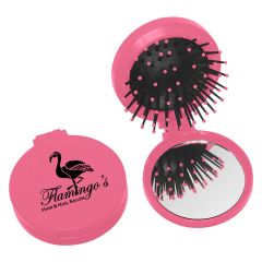 pink brush and mirror with an imprint saying flamingo's hair & nail salon