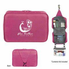 pink toiletry bag with zippered main compartment, multi-compartment pockets, hook to hang, and an imprint saying blue feather salon and spa