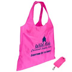 pink foldable bag with an included pouch with a carabiner and an imprint on the bag saying wild ride carnival supply center and everything but the sawdust
