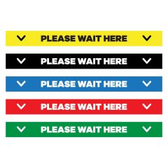 floor decal in yellow, black, blue, red, and green saying Please Wait Here Floor Decal in between two arrows pointing down