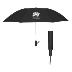 black umbrella with a wrist strap and an imprint saying Whole Earth Foundation